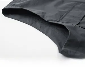 Detail of premium stitching and texture on a men's multi-pocket functional fishing vest