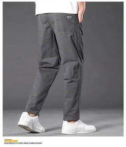 Detail view of cotton cargo pants back pockets with casual straight cut for men