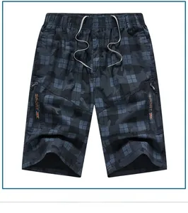 Detailed shot of men's plaid shorts featuring elastic drawstring waist and zipper pockets