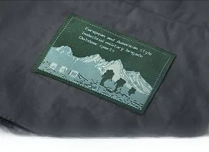 Macro detail of high-quality woven label with mountain motif on utility vest