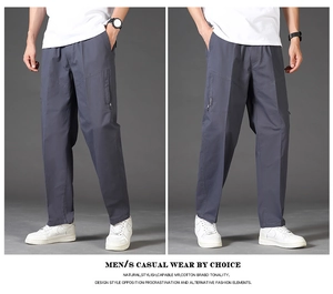 Detail of loose-fit straight men's cotton pants showing zipper pockets and drawstrings