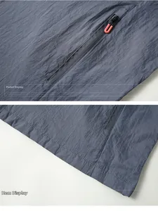 Detail view of the gray-blue sun protection jacket with zip pocket and hem stitching