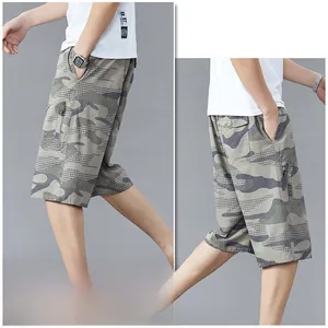 Detail view of camouflage beach shorts featuring side zipper pockets and cotton fabric