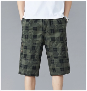 Detail view of cargo shorts pocket with zipper and SPORT woven strap on camo pattern