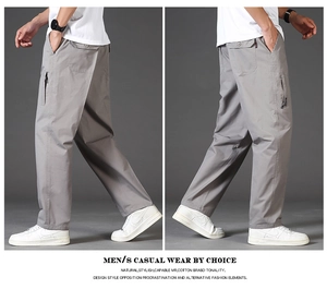 Detail view of grey cotton cargo pants with side zipper pockets and loose straight cut