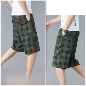 Detail view of men's camouflage plaid shorts featuring side zipper utility cargo pockets
