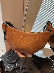 Caramel leopard embossed suede croissant bag with black knot strap and silver zipper