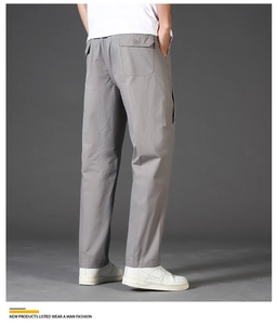 Detail view of men's grey straight-leg casual trousers with a buttoned back pocket
