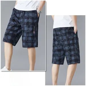 Detail of dark blue plaid shorts featuring elastic drawstring waist and side zip pockets