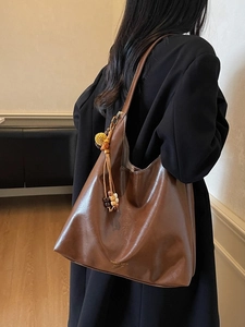 Deep brown minimalist tote bag with large capacity and decorative plush ball keychain