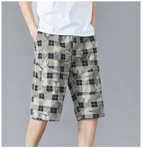 Detail of men's casual checkered shorts featuring camouflage pattern and SPORT label