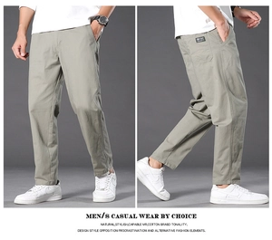 Detail view of men's casual khaki cotton trousers featuring side pockets and woven brand label