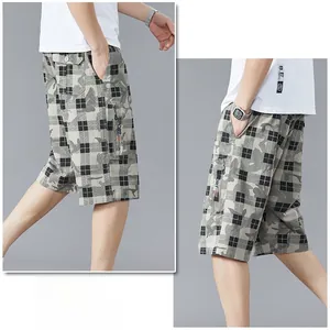 Detail of cargo shorts side pocket with zipper and SPORT embroidery on plaid pattern