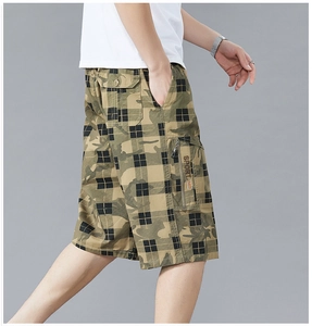 Detail of men's cargo shorts with camouflage plaid pattern and multi-pocket design