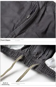 Detail of men's cotton pants featuring a metal zipper fly and internal drawstring
