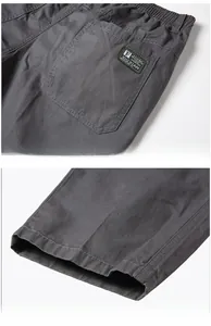 Detail of men's casual pants showing twill cotton texture and stitched back pocket