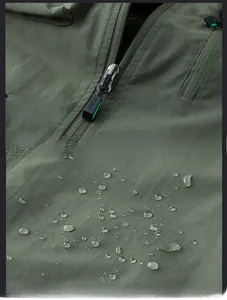 Detail of metal zipper and waterproof fabric texture on men's outdoor utility vest