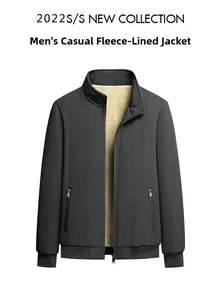 Detail view of men's black winter jacket with warm white fleece lining and stand collar