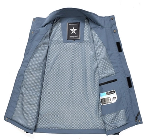 Macro detail of breathable grey mesh lining and internal zipper pocket on blue fishing vest