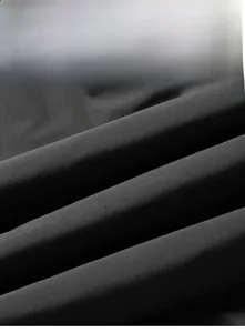 Detailed macro view of black windproof fabric showing scratch-resistant texture for jackets