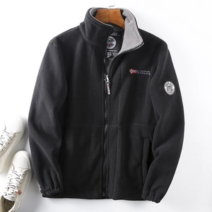 Close-up of black fleece jacket featuring grey lining and Norway flag embroidery detail