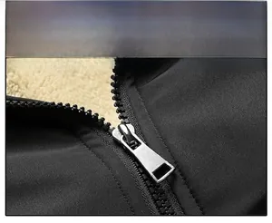Detailed close-up of smooth silver matte metal zipper on black casual winter jacket
