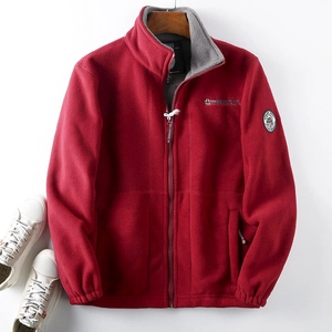 Detailed close-up of a red fleece jacket featuring gray lining and Norway embroidery