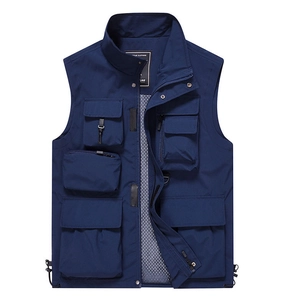 Detail of navy blue utility vest with functional pockets and breathable mesh lining