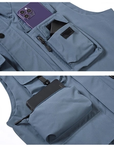 Detail view of multi-pocket fishing vest showing large storage capacity for electronics