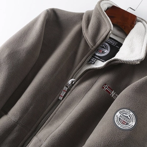 Detail of grey winter fleece jacket showing Norway embroidery and mountain arm badge