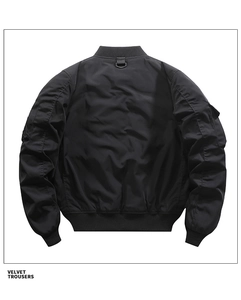 Rear view of black bomber jacket with ribbed collar and metal D-ring detail on back