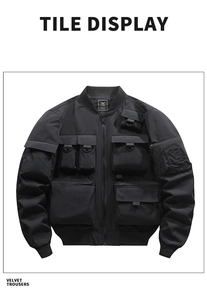 Detailed flat lay of black bomber jacket with multi-pocket utility design and D-ring hooks