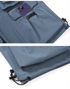 Detail of outdoor vest featuring deep functional side pockets and adjustable hem drawstrings