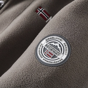 Detailed close-up of high-density thick polar fleece fabric and embroidered outdoor badge