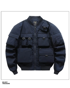 Detail of navy pilot jacket showing multi-pocket cargo design and ribbed knit collar