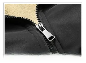Close-up of black zipper with silver metal slider and warm cream fleece lining detail