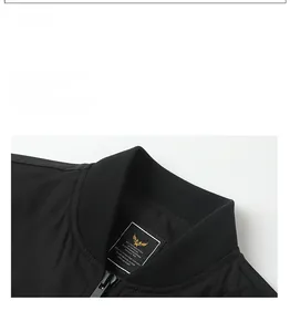 Close-up of the ribbed collar and gold eagle logo label on a black bomber jacket
