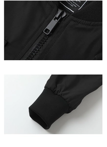 Detail of ribbed collar, resin zipper and elastic cuffs on a black workwear flight jacket