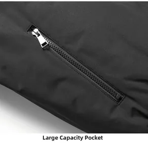 Detailed close-up of a large capacity pocket and metal zipper on the black winter jacket
