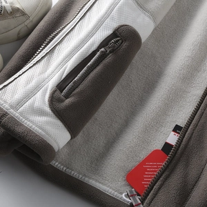 Detail of warm double-layer fleece lining and secure zipper pocket on winter jacket