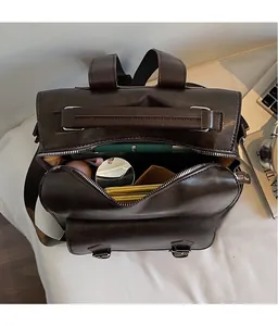 Detail view of wide-opening vintage leather backpack showing spacious internal storage