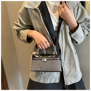Détail d'un sac à main en tweed à chevrons vintage avec garniture en cuir et fermeture argent