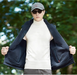 Detail of men's navy fleece vest showing stand collar and warm outdoor lining texture