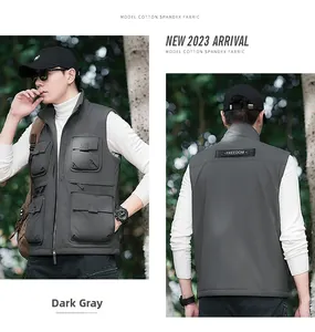 Detail view of a men's dark grey outdoor utility vest with pockets and stand collar