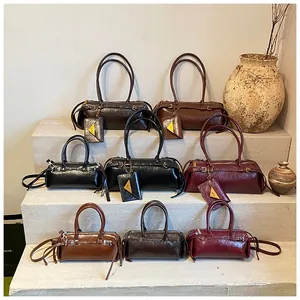 Detail view of retro Boston bags with oil wax leather texture and mini triangle pouches