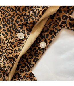 Detail of the magnetic metal snap closure on a leopard print canvas tote bag interior