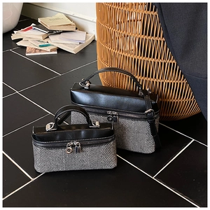 Détail de sacs à main bicolores avec motif à chevrons et rabat en cuir noir élégant
