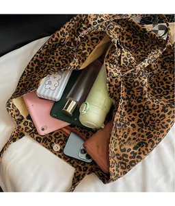 Detail view of leopard print canvas tote bag showing large capacity and metal closure