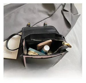Top view showing the internal capacity and black leather design of this small square bag