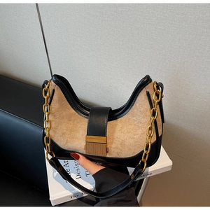 Chic underarm bag in black leather and tan suede with a gold chain strap accent